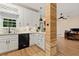 Updated kitchen featuring white shaker cabinets, wood accent wall, and breakfast bar at 2680 Pine Tree Ne Rd # 2, Atlanta, GA 30324