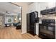 Modern kitchen with black appliances and view into living area at 2680 Pine Tree Ne Rd # 2, Atlanta, GA 30324