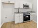 Modern basement kitchen with white shaker cabinets and granite countertops at 4420 Ross Estates Ct, Snellville, GA 30039