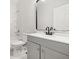 Modern bathroom with gray vanity, a frameless shower, and white fixtures at 4420 Ross Estates Ct, Snellville, GA 30039