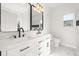 Modern bathroom with white cabinets, marble countertops, and a walk-in shower at 4420 Ross Estates Ct, Snellville, GA 30039