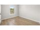 Bedroom with wood-look flooring, a window, and neutral wall colors at 4420 Ross Estates Ct, Snellville, GA 30039