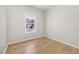 Well-lit bedroom with wood-look floors and a window offering a view at 4420 Ross Estates Ct, Snellville, GA 30039