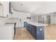 Modern kitchen with white cabinets, quartz countertops, and a large island at 4420 Ross Estates Ct, Snellville, GA 30039