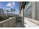 This balcony features wood style flooring, gray railing, and views of the community at 6442 Canopy Dr, Sandy Springs, GA 30328