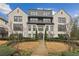 Charming townhome with landscaped front yard and timeless brick facade with black trimmed windows at 6442 Canopy Dr, Sandy Springs, GA 30328