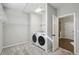 Bright laundry room with carpet floor, modern washer and dryer and wire shelving at 6442 Canopy Dr, Sandy Springs, GA 30328