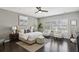 Spacious main bedroom with a plush bed and two comfy armchairs at 6442 Canopy Dr, Sandy Springs, GA 30328