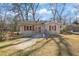 Gray house with red shutters, a small front porch, and a paved driveway at 1044 Pinedale Se Dr, Smyrna, GA 30080