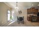 Bright dining area with four-chair table, pendant lighting, and access to the kitchen at 2777 Lakeview Walk, Decatur, GA 30035