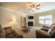 Living room with fireplace, large windows and ceiling fan at 2777 Lakeview Walk, Decatur, GA 30035