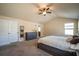 Main bedroom with high ceilings, king bed, and access to bathroom at 2777 Lakeview Walk, Decatur, GA 30035