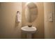 Small powder room with pedestal sink and oval mirror at 2777 Lakeview Walk, Decatur, GA 30035