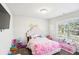 Cozy bedroom with a pink bedspread and plenty of natural light at 3216 Colchester St, Douglasville, GA 30135