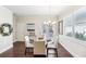 Dining area with glass table, chandelier, and access to backyard at 3216 Colchester St, Douglasville, GA 30135