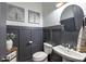 Modern powder room with dark gray walls and white vanity at 364 Concord St, Alpharetta, GA 30009