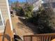 View of backyard from wooden deck stairs, surrounded by lush greenery and mature trees at 522 Spring View Dr, Woodstock, GA 30188