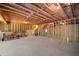 Unfinished basement with exposed ceiling beams and concrete floor, offering endless possibilities at 522 Spring View Dr, Woodstock, GA 30188