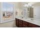 Bathroom features double vanity, a large mirror, and natural light from the window at 522 Spring View Dr, Woodstock, GA 30188