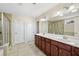 Bathroom features a double vanity, tiled floors, a glass-enclosed shower, and ample storage space at 522 Spring View Dr, Woodstock, GA 30188