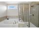 Modern bathroom with soaking tub, walk-in shower, and window at 522 Spring View Dr, Woodstock, GA 30188