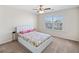 Cozy bedroom with neutral carpet, ceiling fan, and natural light from the window at 522 Spring View Dr, Woodstock, GA 30188