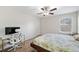 Bedroom with carpeted floor, ceiling fan, and home office space at 522 Spring View Dr, Woodstock, GA 30188