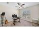 Bright bedroom features a ceiling fan, a desk with computer setup, and ample natural light at 522 Spring View Dr, Woodstock, GA 30188