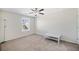 Neutral bedroom with plush carpet, ceiling fan, and a sunny window at 522 Spring View Dr, Woodstock, GA 30188