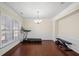 Dining room with hardwood floors, chandelier, and treadmill at 522 Spring View Dr, Woodstock, GA 30188