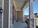 Covered front porch with brick columns and flooring at 522 Spring View Dr, Woodstock, GA 30188