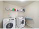 Laundry room with washer, dryer, shelving, and ironing board at 522 Spring View Dr, Woodstock, GA 30188