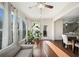 Sun-drenched living room features hardwood floors and an abundance of healthy potted plants at 522 Spring View Dr, Woodstock, GA 30188