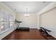 Bright, open-plan room with ample light, hardwood floors, and neutral-colored walls at 522 Spring View Dr, Woodstock, GA 30188