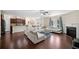 Open-concept living room with hardwood floors, fireplace, and kitchen view at 522 Spring View Dr, Woodstock, GA 30188