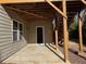 Covered back patio area with access to the house and stairs to the upper deck at 522 Spring View Dr, Woodstock, GA 30188
