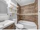 Updated bathroom with wood-look tile and floating shelves at 2234 Cherokee Valley Dr, Lithonia, GA 30058