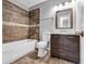Renovated bathroom, featuring a new vanity and bathtub at 2234 Cherokee Valley Dr, Lithonia, GA 30058