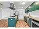 Modern kitchen with stainless steel appliances and green cabinetry at 2234 Cherokee Valley Dr, Lithonia, GA 30058