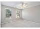 Well-lit bedroom featuring neutral walls, ceiling fan and carpet at 1016 Madeline Ct, Loganville, GA 30052