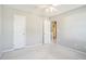 Bedroom with neutral walls, ceiling fan, carpet, and double doors at 1016 Madeline Ct, Loganville, GA 30052