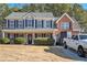 Two-story house with gray and brick exterior, landscaping, and a driveway at 1016 Madeline Ct, Loganville, GA 30052