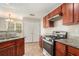 Modern kitchen with stainless steel appliances and rich wood cabinetry at 1016 Madeline Ct, Loganville, GA 30052