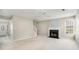 Living room with fireplace, ceiling fan, and neutral color palette at 1016 Madeline Ct, Loganville, GA 30052