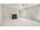 Living room with fireplace, ceiling fan, and neutral color palette at 1016 Madeline Ct, Loganville, GA 30052