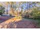 Large backyard with mature trees and a partially fenced area at 2196 Knoll Dr, Decatur, GA 30032