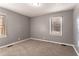 Spacious bedroom with gray walls, carpet, and two windows at 2196 Knoll Dr, Decatur, GA 30032