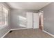 Gray-walled bedroom with carpet, window, and double doors at 2196 Knoll Dr, Decatur, GA 30032