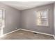 Simple bedroom with gray walls, carpet, and two windows at 2196 Knoll Dr, Decatur, GA 30032