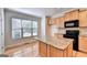 Bright kitchen with granite island and hardwood floors at 2790 Laurel Valley Trail, Buford, GA 30519